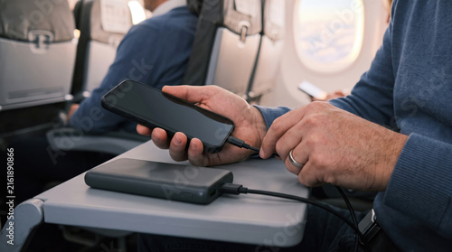 Charging a mobile phone with a power bank during a flight