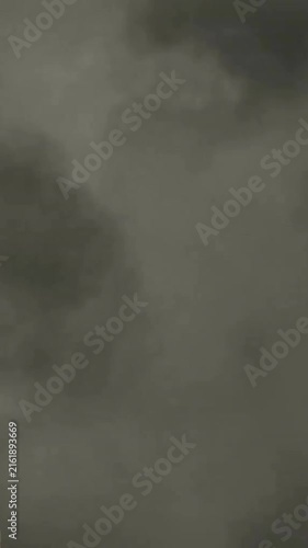 Animation of gray sculpture of man over dark sky and clouds, copy space