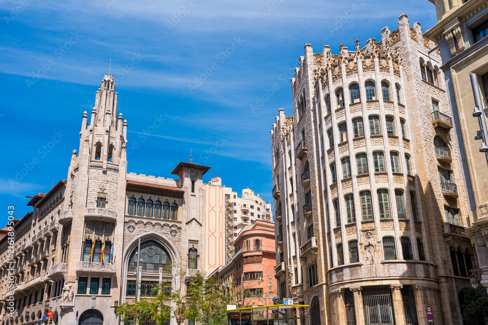 Obraz premium Two Historical Caixa Buildings in Barcelona City in Spain