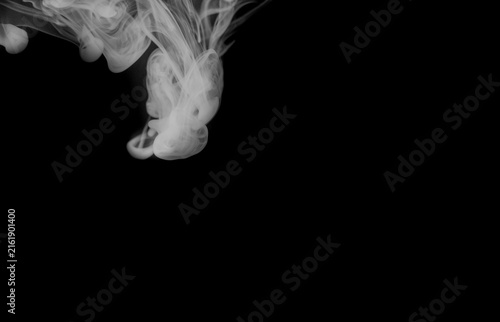 Фотография A powerful surge of white smoke erupts from below, creating a dramatic visual effect with its dense and swirling textures in black