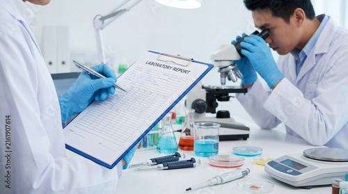 Professional medical scientists conducting research in a modern chemical laboratory with microscope transparent background