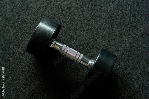 Set of dumbbells of various weights neatly arranged on rack in modern gym, organized strength training equipment storage solution for fitness center, weight room or professional workout space