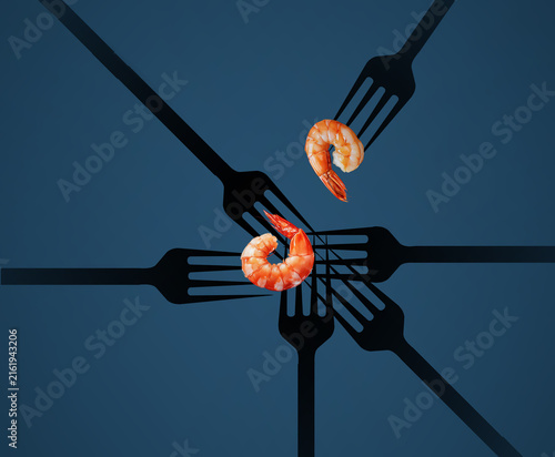 Cooked shrimp are seen with silhouettes of dinner forks in a graphic design about this fabulous seafood item.