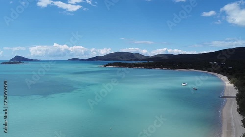Aerial drone footage of Whitsundays coastline and calm blue water
