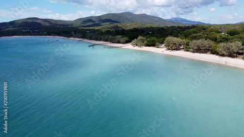 Drone video of tropical beach and turquoise water near Airlie Beach