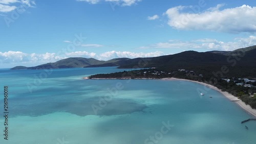 Drone view of beach shoreline and turquoise sea near Airlie Beach