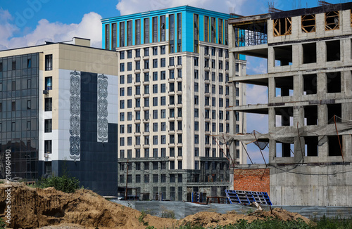 Modern residential district featuring completed apartment buildings alongside residential buildings still under construction, illustrating ongoing urban growth and housing development. Oskemen KZ