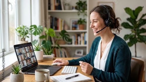 Woman with headset working on online meeting at home with books and plants in background