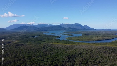 Drone view of tropical estuary and mountains near Cardwell
