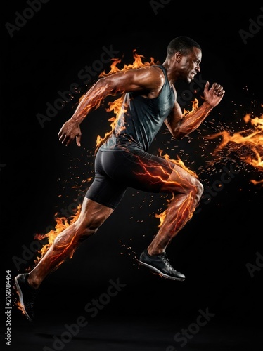 Dynamic Athlete Ignited by Flames in Powerful Sprint.