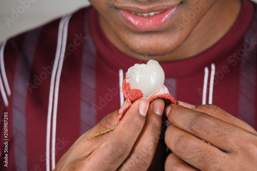 Eating lychee fruit in a home kitchen