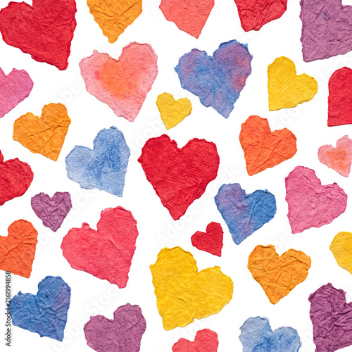 A seamless and artistic pattern of various colorful torn paper hearts, creating a loving texture.
