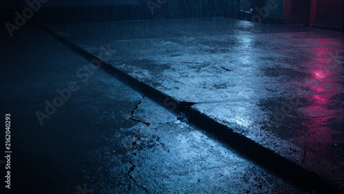 Dark industrial cracked concrete floor with dramatic blue and red neon lighting