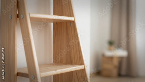empty ladder against a soft blurred cozy room 