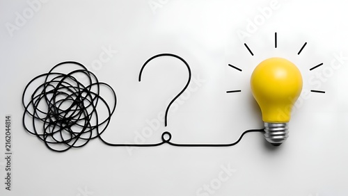 Tangled wire transforming into a question mark and glowing yellow lightbulb symbolizing problem solving and creative business solutions