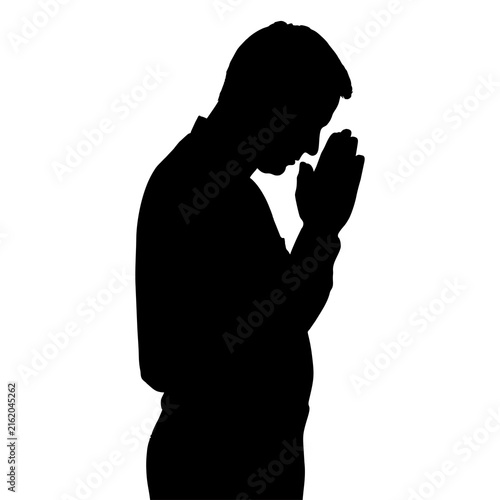 Obraz na plátně Black silhouette of a man praying WITH HIS HANDS IN THE FIST
