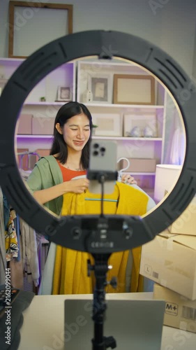 Asian woman Gen Z live streaming fashion clothing sales and looking at camera,social commerce influencer web broadcasting,e-business,e-commerce on entrepreneur,order confident,new business for gen Z