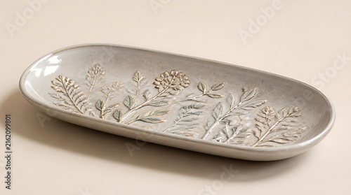 Elegant Handcrafted Ceramic Oval Platter Featuring Delicate Embossed Floral and Botanical Leaf Patterns on a Neutral Beige Background for Home Decor and Kitchenware Display