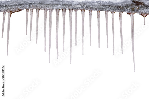 Transparent melting icicles hanging from the edge