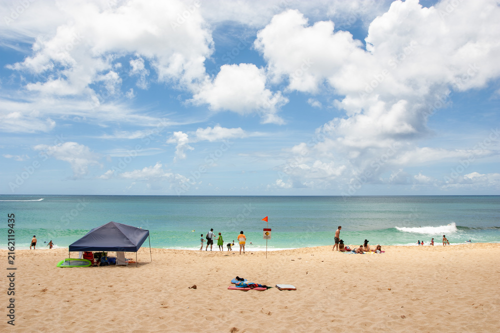 Fototapeta premium People Relaxing at Sunset Beach on Oahu North Shore, Hawaii
