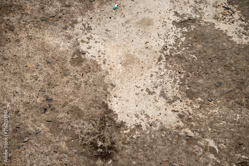 Obraz na plátně An old, weathered, and dirty concrete or cement floor surface featuring a blend of brown and light gray tones, scattered gravel, and minor staining