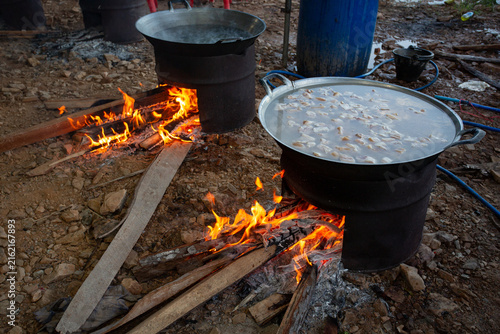 The wood-burning stove is currently cooking food in a pan.