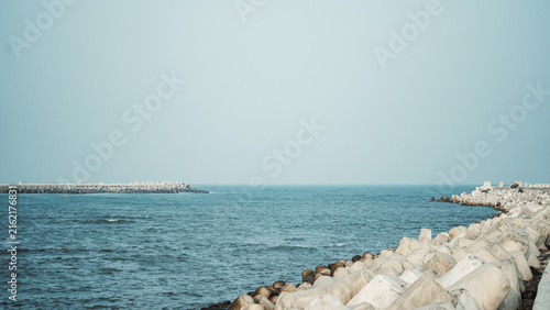 фотографія Tetrapods on the beach are useful for breaking sea waves