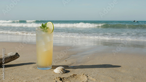 Refreshing citrus drink in jar with mint on sandy beach at sunset PNG, 4K, HD Image