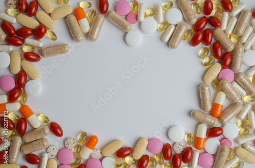 Colorful tablets capsules pills medicine heap frame border White background Copy space for text Drugs vitamins Concept of healthcare treatment pharmacy modern medicine Pay attention to your health