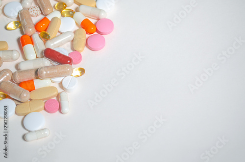 Colorful tablets capsules pills medicine heap border White background Copy space for text Drugs vitamins Concept of healthcare treatment pharmacy modern medicine Pay attention to your health