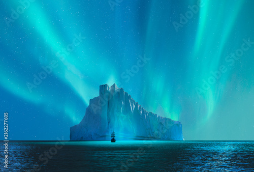 Foto A large sailing ship navigating through icy waters, with towering icebergs in th