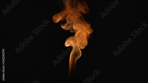 Orange smoke plume swirling against a dark black background