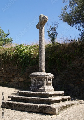 Ancient stone Calvary cross standing in the rural Portuguese village of Quintadona, Portugal - Norte