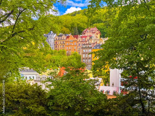 Colorful buildings in Karlovy Vary surrounded by green trees