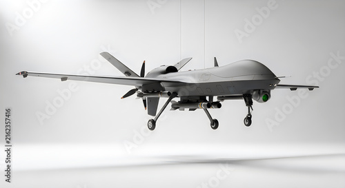 Gray military drone with propellers and weapons suspended on white background for display.