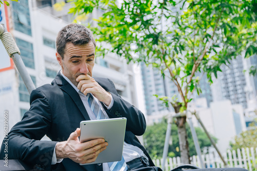 Quadro su tela Businessman Stressed while Reading at Tablet Feel Worried Bad News Financial Los