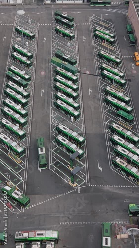 Aerial view of electric buses parked at charging stations in San Donato Milanese, Milan, Italy, illustrating modern public transport and clean energy infrastructure.