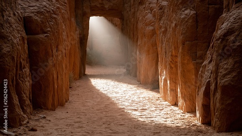 Dramatic sunbeam illuminates ancient canyon path, creating a mystical journey through rock formations