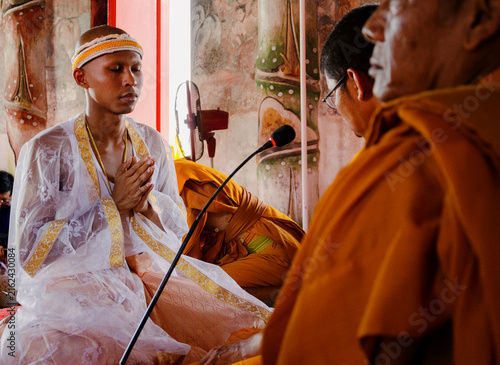 Canvastavla A pre-ordained monk, aka Naga (นาค), is praying inside a Buddhist temple during