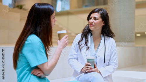 Medical professionals having coffee break and discussing work