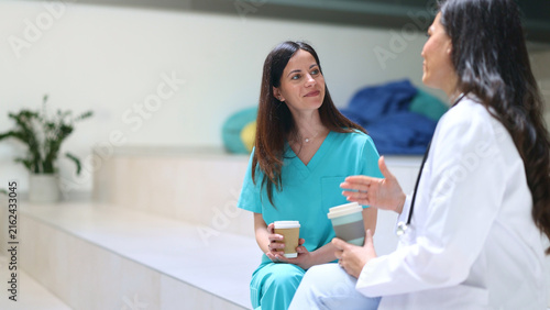 Medical professionals having coffee break and discussing work