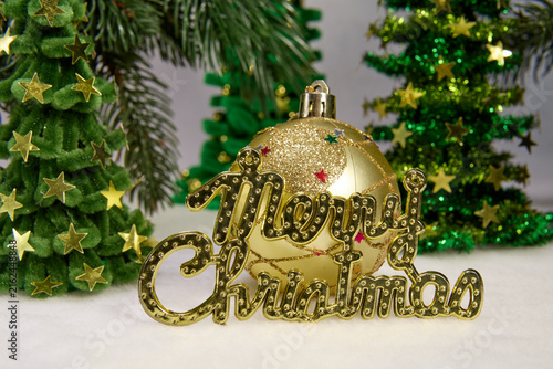 A pine cone with letters among green fir trees