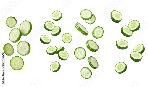 Obraz na płótnie Dynamic arrangement of fresh green cucumber slices, many suspended in motion, on a transparent background