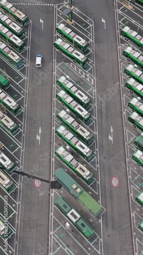 Aerial view of electric buses parked at charging stations in San Donato Milanese, Milan, Italy, illustrating modern public transport and clean energy infrastructure.