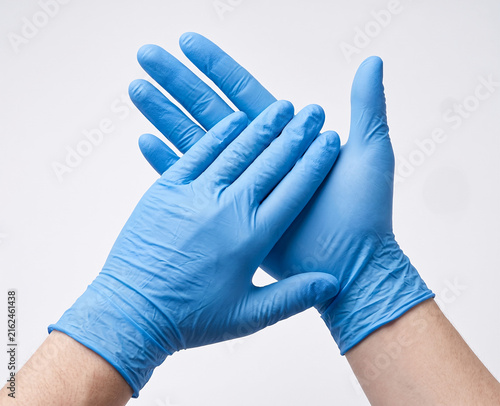 Bild auf Leinwand Hands Wearing Blue Nitrile Medical Gloves Isolated on White Background