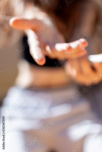 Canvas Print Blurred hand reaches outward capturing motion and body language during energetic teenage dance movement