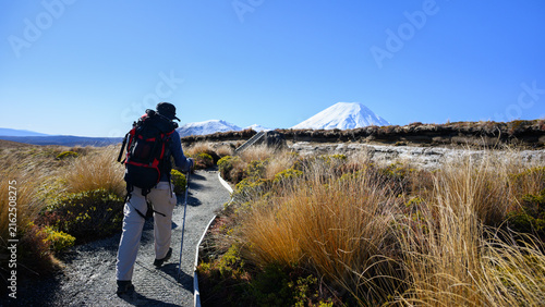 Hiking Tama Lake Tracks in winter. Snow-capped Mount Ngauruhoe in the distance. Tongariro National Park. New Zealand.