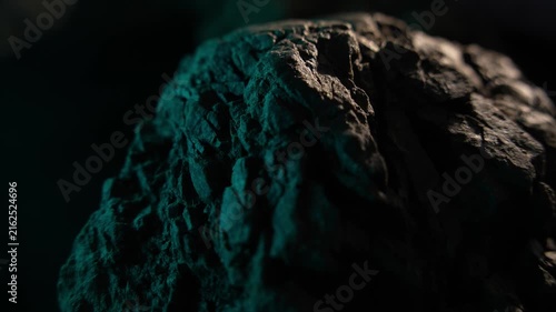 Rock surface close up with soft light and dark cinematic background