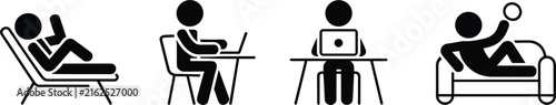 Four people working at desks, sitting, typing, and reading on laptops and papers desi