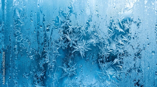 Close-up abstract icy blue frost texture with crystalline winter cold background pattern